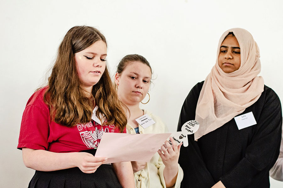 group of young people discussing and presenting to each other