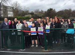 group of children and adults opening a new space in the community