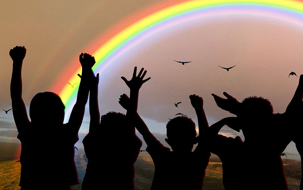 group of young people throwing their hands in the air