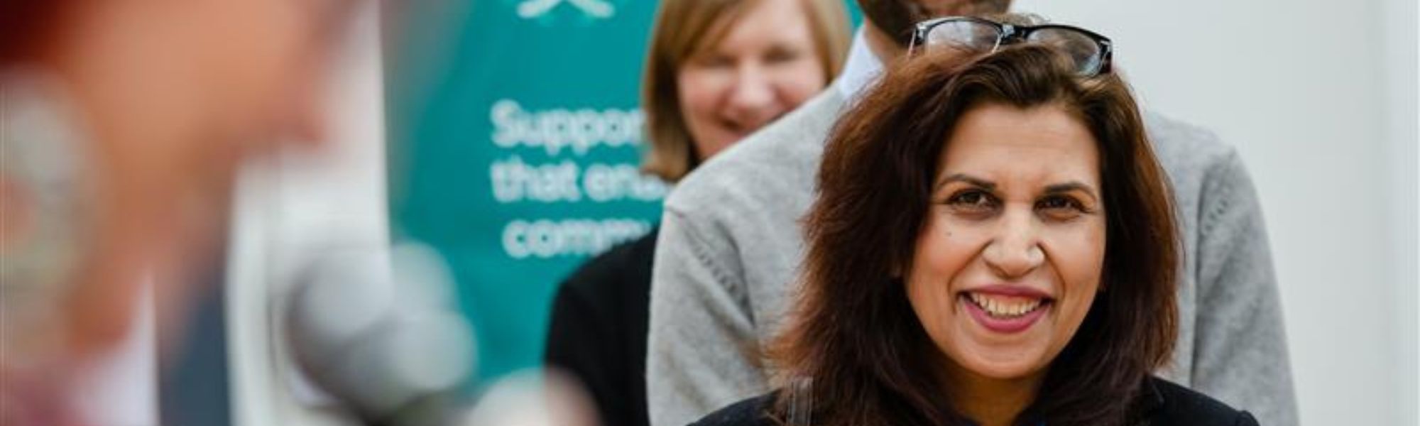 a staff member smiling at a Corra event