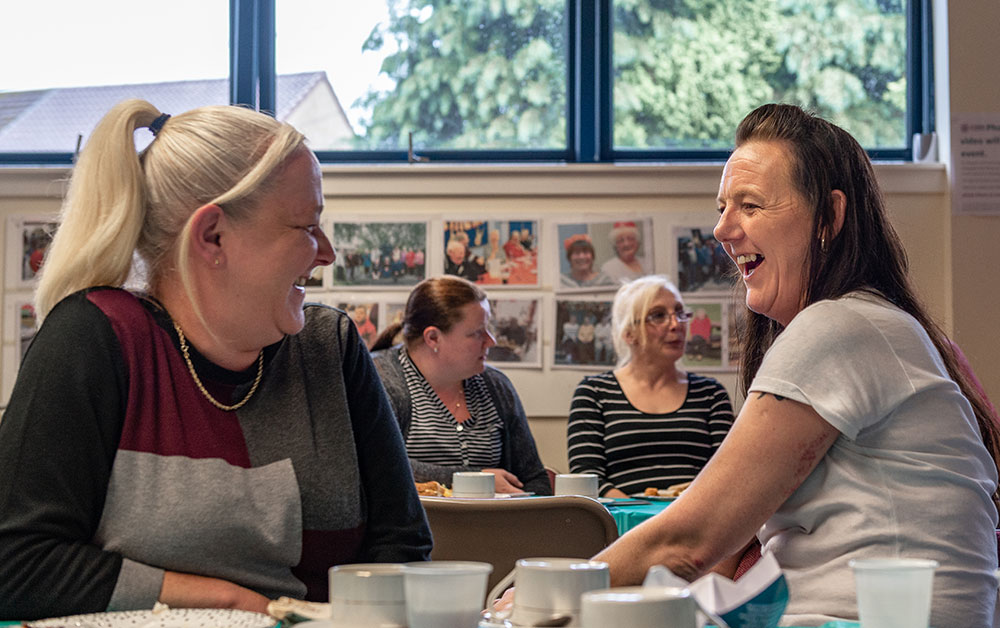 two adults talking and laughing