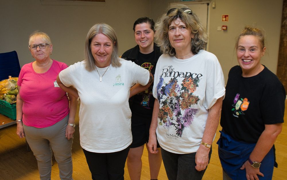 group of volunteers smiling and working together