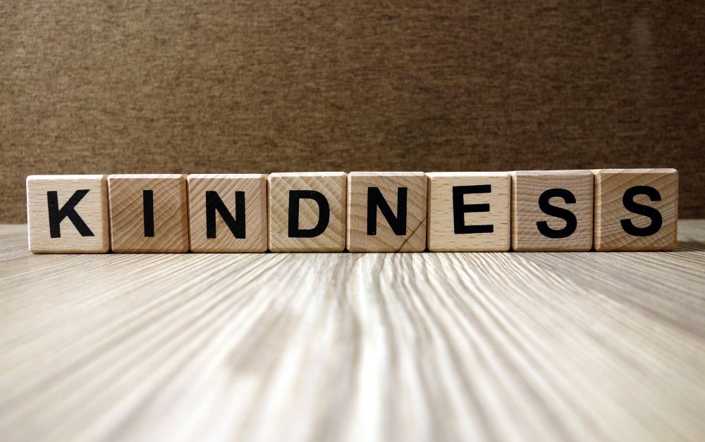 line of wooden blocks that spell out the word kindness