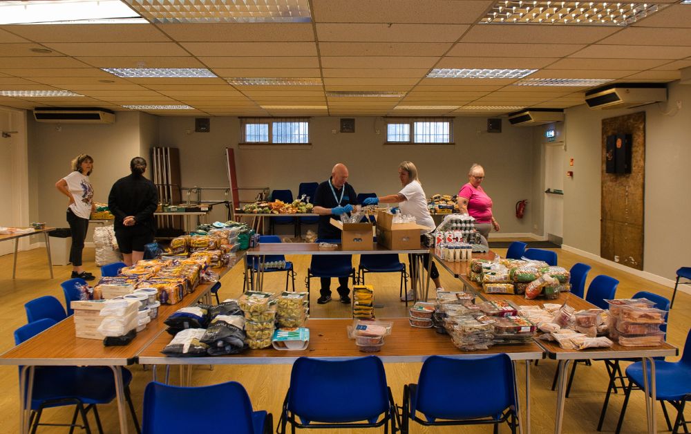 dunterlie foodshare volunteers with food on tables