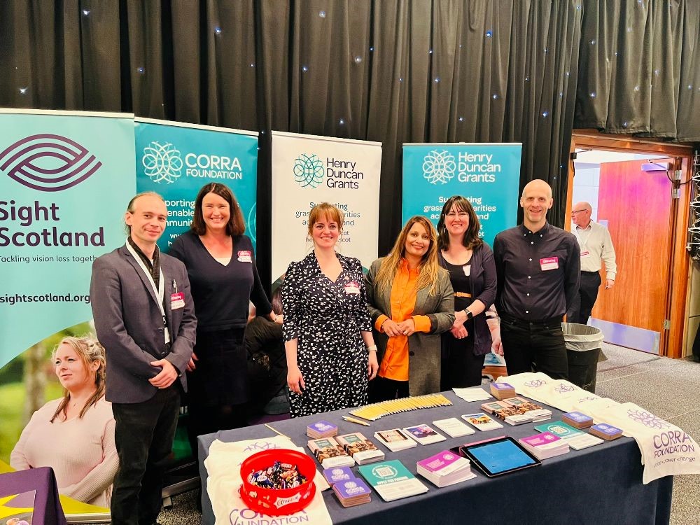 Corra staff members gathered round the Corra exhibition stall at the Gathering
