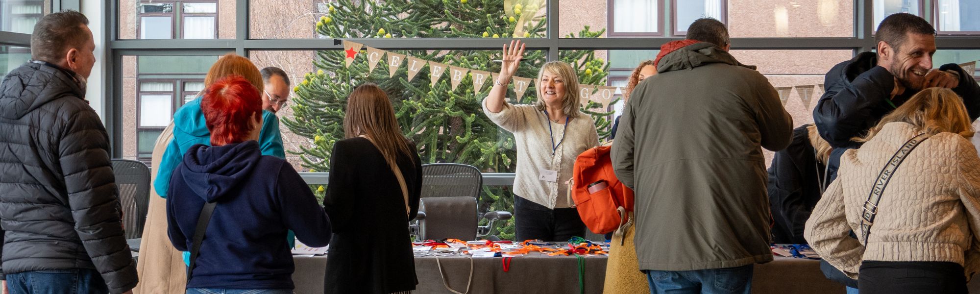 a staff member smiling at a Corra event